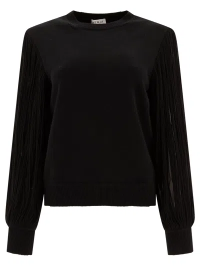 Alaïa Slit Fringe Sleeve Wool Crewneck Sweater In Black